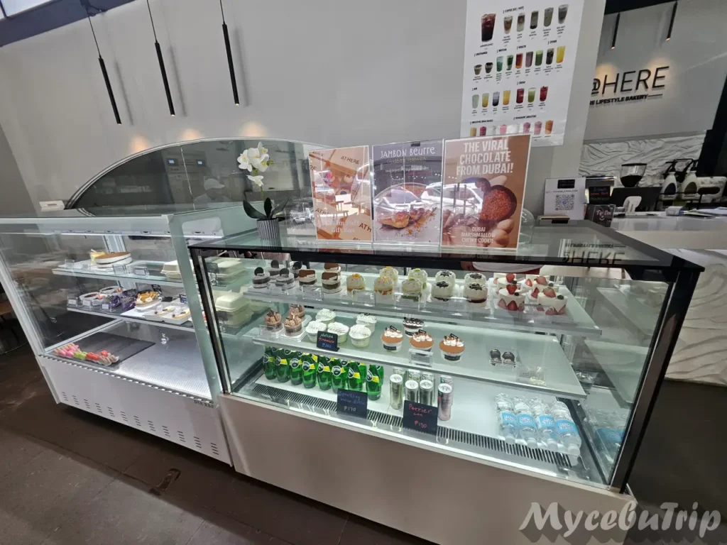 Refrigerated display case filled with fresh strawberry cakes and premium desserts at AT@HERE Bakery Mactan.