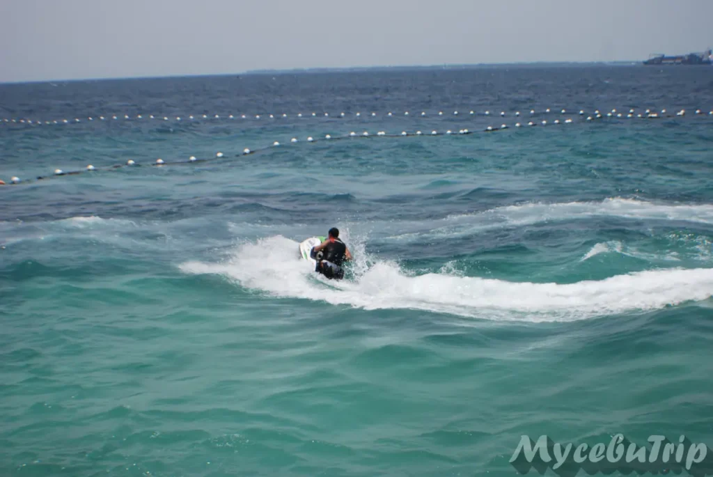 A person riding a jet ski near the coast of Mactan, Cebu