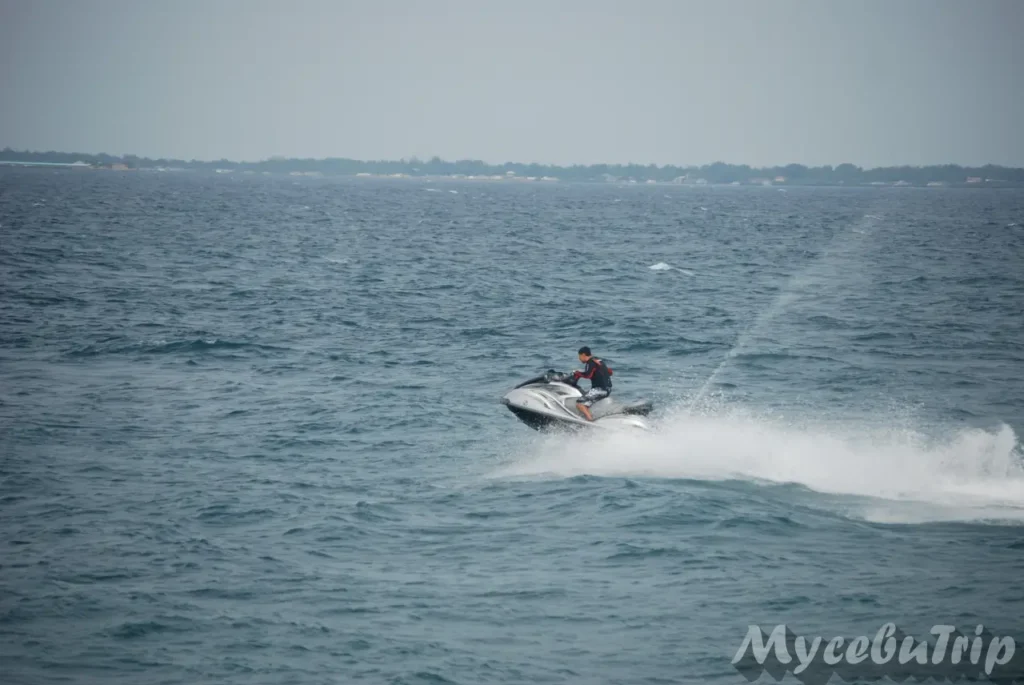 A person driving a jet ski across the open water in Mactan, Cebu